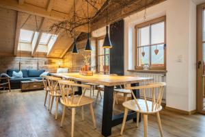 a dining room with a wooden table and chairs at Valentin36 Apartment Ritten in Funes