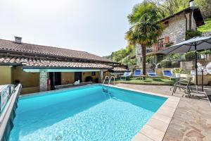 a swimming pool in the backyard of a house at Residence Tatiana B3 in Tremosine Sul Garda