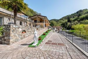 a statue in the middle of a brick road at Residence Tatiana B3 in Tremosine Sul Garda