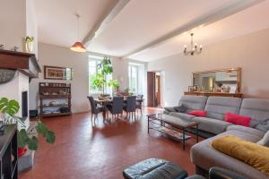 a living room with a couch and a table at Chambres D'hôtes Maison Galouÿe in Montgaillard