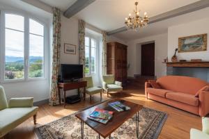 a living room with a couch and a table at Chambres D'hôtes Maison Galouÿe in Montgaillard