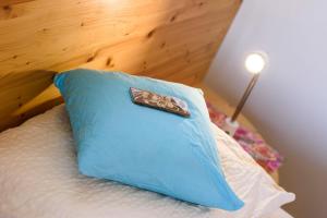 a blue pillow sitting on top of a bed at Peter Paul Studio Buchwald in Appiano Sulla Strada Del Vino