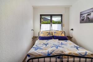 a bed in a room with a window at Haus Schlossgarten in Hinte