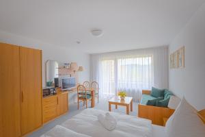 a bedroom with a bed and a living room at Fewo Schneckenhalde App 18 in Bad Säckingen