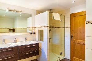 a bathroom with a sink and a shower at Ferienwohnung Kraus Eibsee in Grainau +17 photos