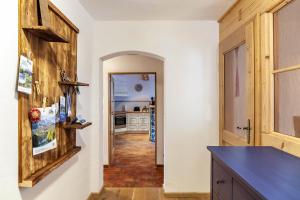 a kitchen with white walls and a wooden door at Ferienwohnung Kraus Eibsee in Grainau