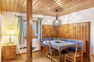 a dining room with a blue table and chairs at Ferienwohnung Kraus Eibsee in Grainau