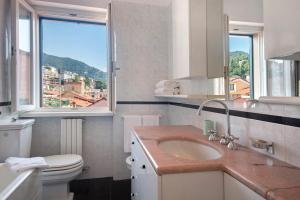 a bathroom with a sink and a toilet and a window at Appartamento Gabbiano in Rapallo +23 photos