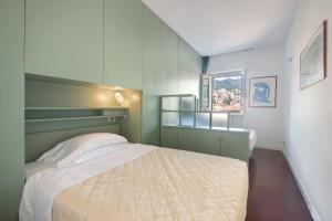 a small bedroom with a bed and a window at Appartamento Gabbiano in Rapallo