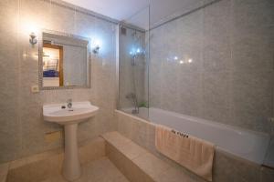 a bathroom with a sink and a shower and a tub at Sa vinya in Colonia de Sant Pere +17 photos
