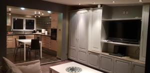 a kitchen with a table and a tv in a room at Le Coq De Champagne in Dormans +19 photos