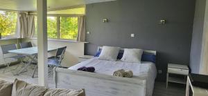 a bedroom with a bed and a table and chairs at Le Coq De Champagne in Dormans