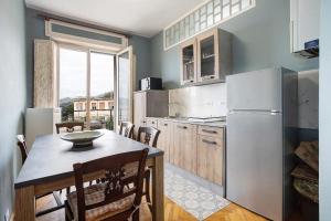 a kitchen with a table and a refrigerator at 5 Terre - Lerici - Aless View in Lerici