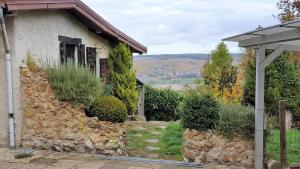 a house with a stone wall with a view at Le Coq De Champagne in Dormans