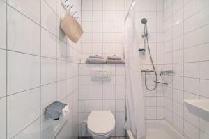 a white bathroom with a toilet and a shower at Wiff's Studio in Mellau +14 photos