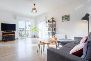 a living room with a couch and a table at Urania - Escale centre Concarneau in Concarneau