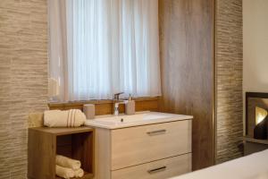 a bathroom with a sink and a mirror at Ferienwohnung Dina in Haslach im Kinzigtal +22 photos