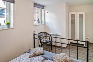 a bedroom with a bed and a chair at Wohnung 4 in Wallhausen