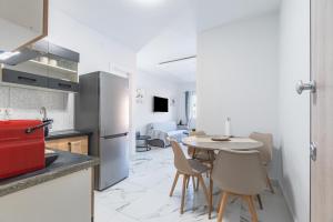 a kitchen and dining room with a table and chairs at Corfu Haven in Ágios Rókkos