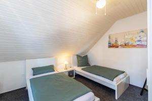 two beds in a small room with at Lichtblick in Bottrop