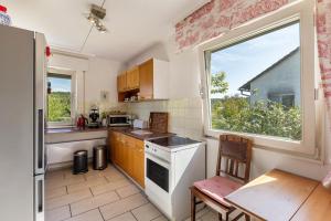 a kitchen with a large window and a table with a chair at Ferienwohnung Oberamsel in Marburg an der Lahn
