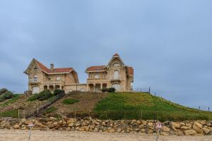 two large houses sitting on top of a hill at Maison 3 étoiles, 300m de l’Océan in Biscarrosse