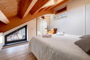 a bedroom with a large bed and a large window at Relax and Happiness private Jacuzzi in Perledo +32 photos