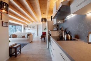 a kitchen and living room with a couch at Relax and Happiness private Jacuzzi in Perledo