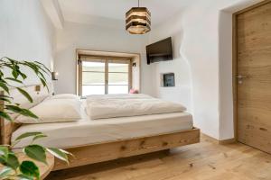 a bedroom with a bed and a window at Labe Biohof Oberzonn in Kastelruth +24 photos