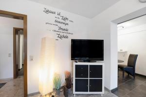 a living room with a flat screen tv on a wall at Fewo Nele in Gries