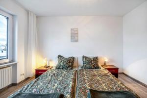 a bedroom with a bed with two pillows at Fewo Nele in Gries