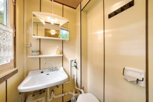 a bathroom with a sink and a toilet at Bungalow 17 - Kimbucht in Reichendorf +18 photos