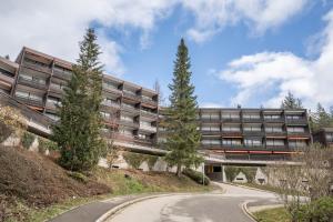 an external view of an apartment building with a winding road at Terrassenpark Apartment 160 in Schonach