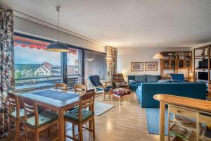 a living room with a table and a couch at Terrassenpark Apartment 160 in Schonach
