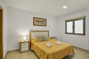 a bedroom with a bed with two towels on it at Edificio Bentejui 1 in Las Palmas de Gran Canaria