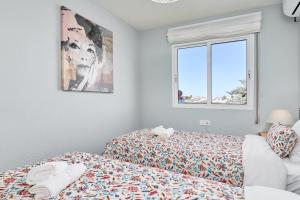 a bedroom with a bed and a window at Vakantiewoning Torrox Park 300 in Torrox +26 photos