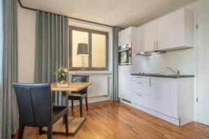 a kitchen and dining room with a table and chairs at 1 Zimmer-appartment Nr 11 in Wangen im Allgäu +16 photos