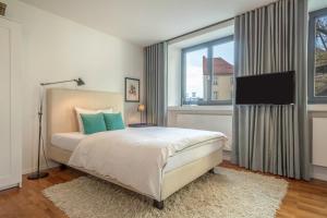 a bedroom with a bed and a large window at 1 Zimmer-appartment Nr 11 in Wangen im Allgäu
