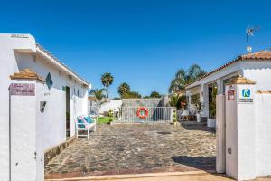 a courtyard of a house with a fence at Casa Mirajanda in Vejer de la Frontera