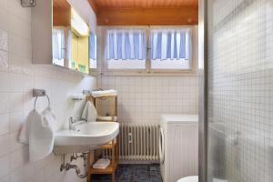 a white bathroom with a sink and a mirror at Deluxe Apartment Ferienwohnung in Wieden +30 photos