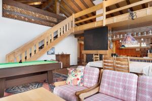 a room with a pool table and a dining room at Deluxe Apartment Ferienwohnung in Wieden