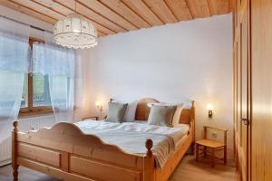 a bedroom with a bed and a chandelier at Deluxe Apartment Ferienwohnung in Wieden