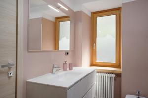 a bathroom with a sink and a mirror at Casa Picchio in Rabbi +20 photos