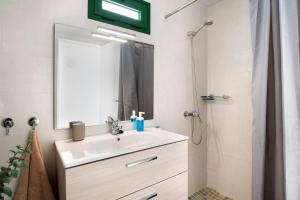 a bathroom with a sink and a mirror and a shower at San Roque 2 in Tinajo +12 photos