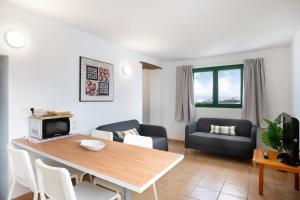a living room with a table and a couch at San Roque 2 in Tinajo