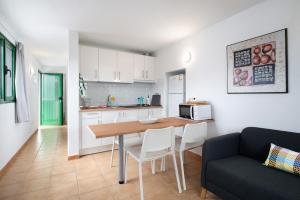 a kitchen and living room with a table and a couch at San Roque 2 in Tinajo