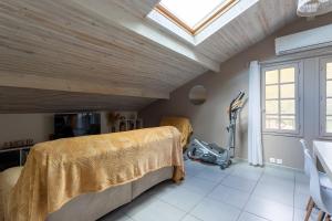 a bedroom with a bed and a skylight at Maison Xara-heguia in Hasparren