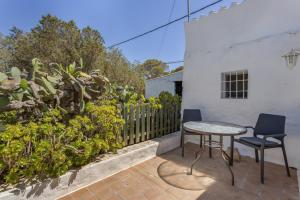 a patio with a table and chairs and a fence at Can Vital 1 in Illes Balears