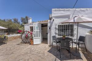 a patio with an umbrella and a table and chairs at Can Vital 1 in Illes Balears +9 photos
