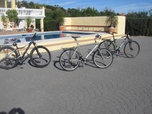 three bikes parked next to a swimming pool at Roca Penthouse in Estepona